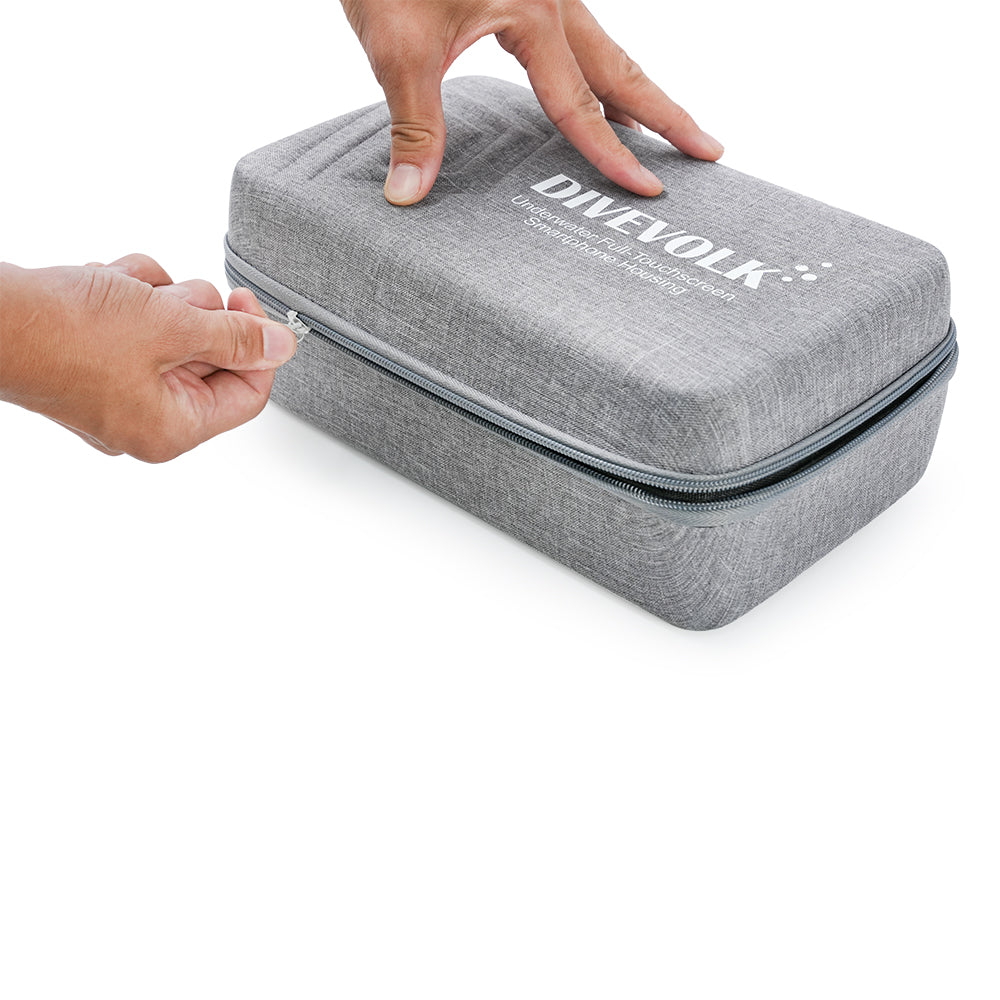 Hands zipping open DIVEVOLK travel case ¡ª grey EVA hard shell with heavy-duty zipper showing compact and portable design.